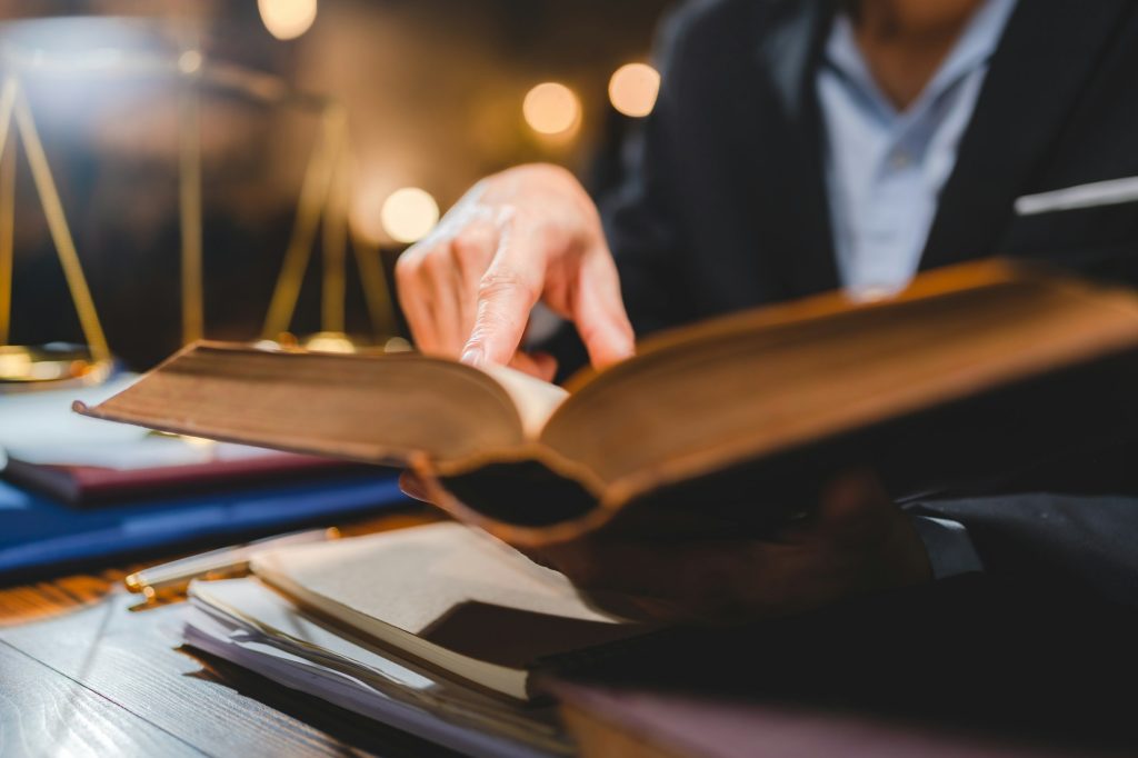 A Successful businessmen's hand reading contract or agreement books; Lawyers